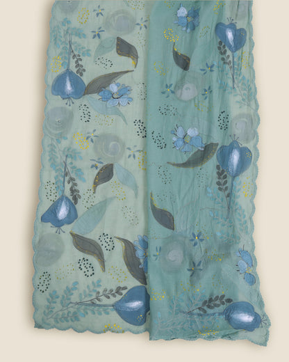 A light teal-green sheer fabric scarf or shawl with scalloped edges, decorated with a hand-painted style floral and leaf pattern in shades of blue, gray, and olive green.
