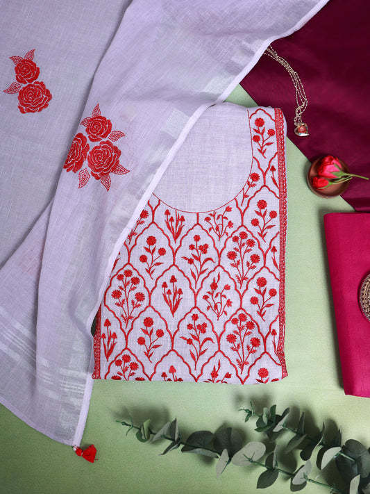 A styled flat-lay of a white cotton kurta with red floral embroidery, paired with a white dupatta featuring red rose embroidery, set against a light green background with decorative eucalyptus leaves and a maroon clutch.