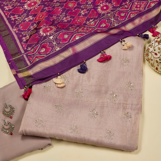 Purple and gray embroidered fabric with decorative elements on a light background